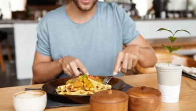 cropped portrait happy young bearded male t shirt smiling cheerfully while enjoying tasty meal during lunch cozy restaurant sitting wooden table 273609 1965